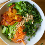 This authentic Shrimp Noddle Bowl is a quick, cozy weeknight meal made with seasoned shrimp, a host of fresh veggies, rice noodles, and a tangy broth.